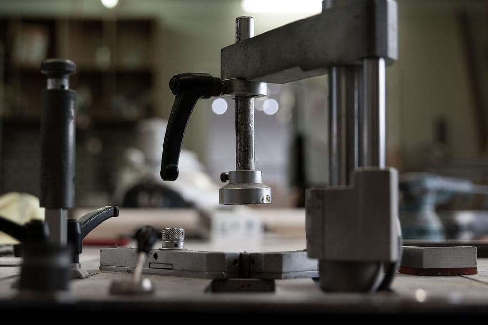 Machinery and tools in a workshop - a stand-in for the SUNLU FilaDryer S4, not a photograph of this model