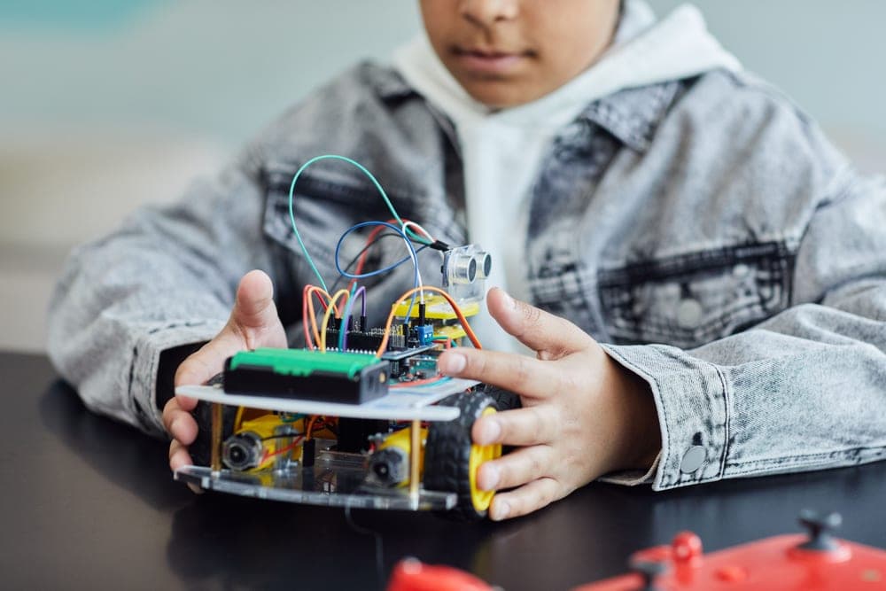 A child's plastic construction toy with visible wires and wheels - a stand-in for the Toybox 3D Printer, not a photograph of this model
