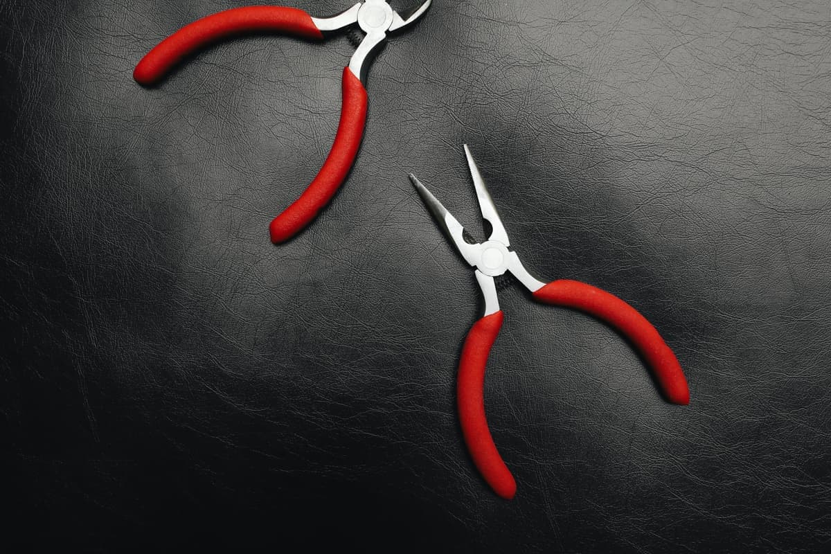 A pair of pliers on a dark surface