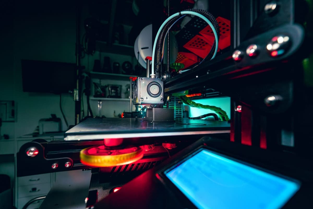 A 3D printer running in a dimly lit room