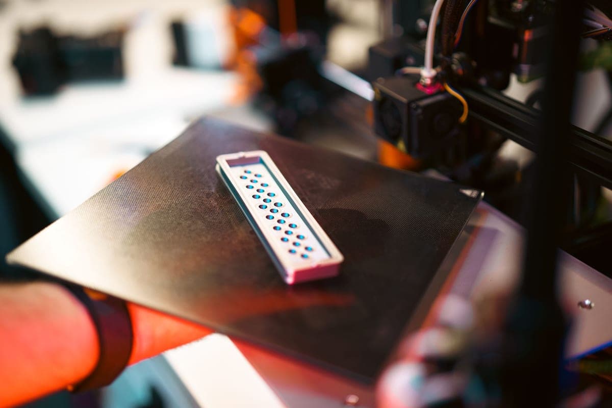 A 3D printer laying down a precise test print in a workshop