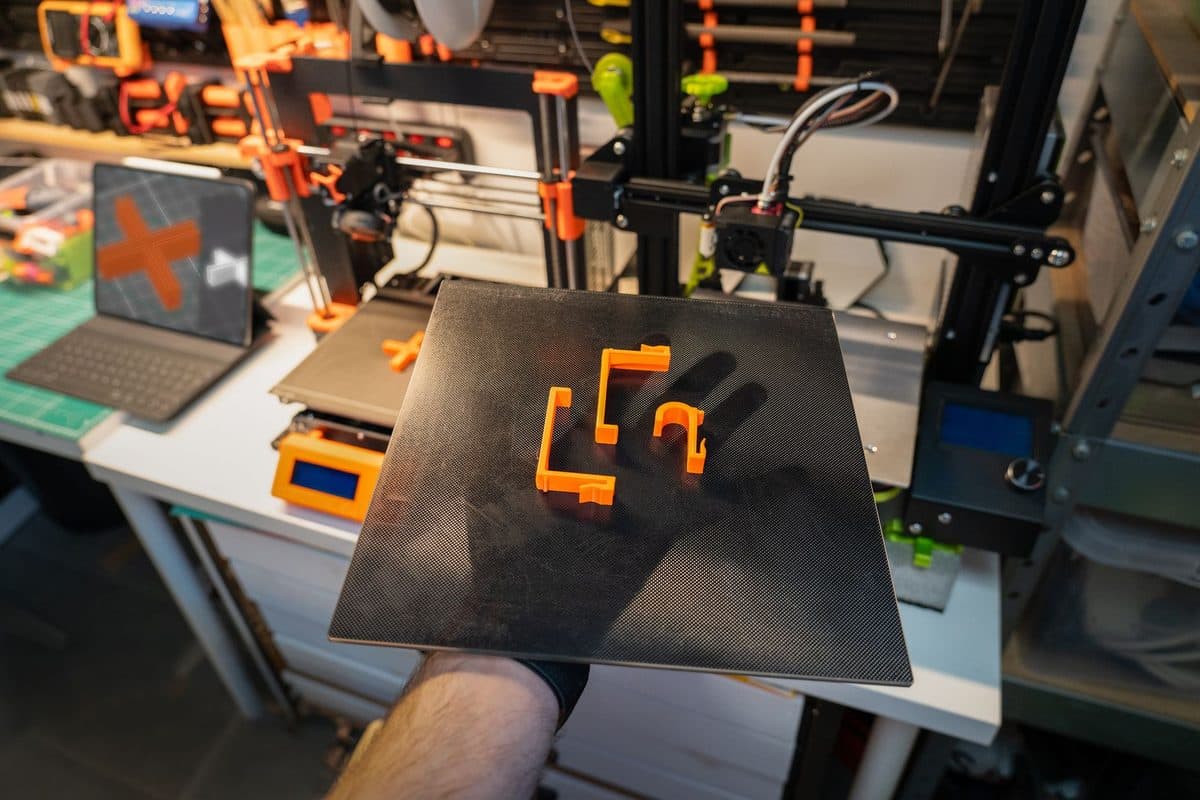 A 3D printer and finished printed parts in a workshop