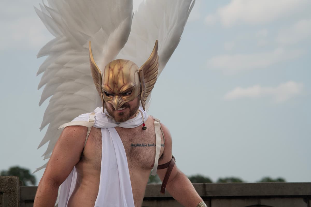 A person in a fantasy costume with a helmet, photographed outdoors