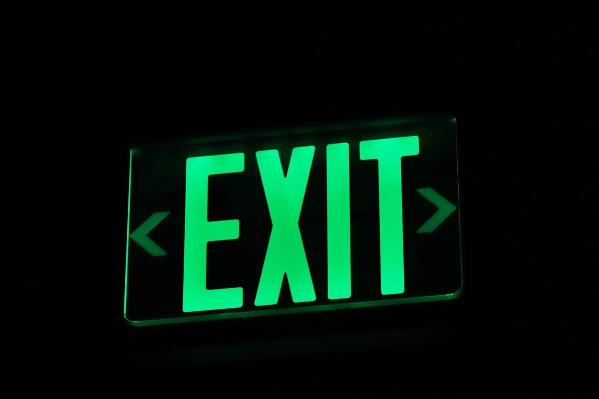 A bright green sign glowing in a dark room