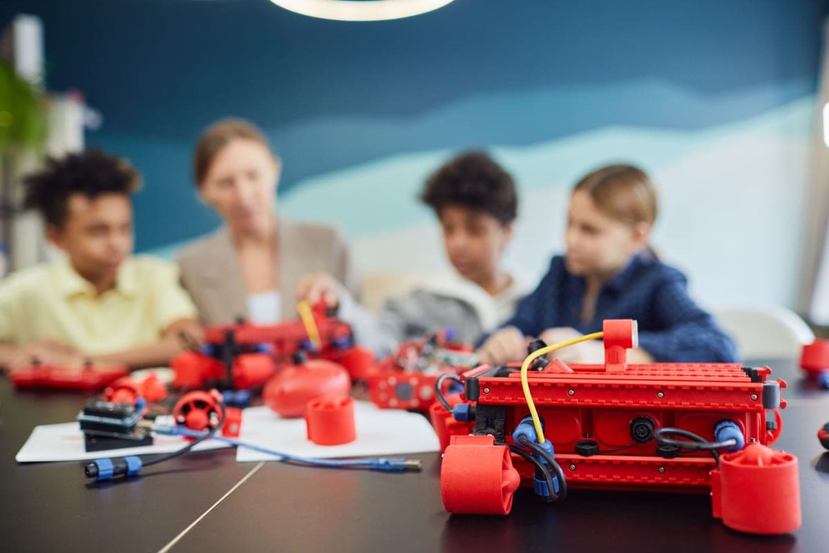 A child's plastic construction toy with wires and wheels