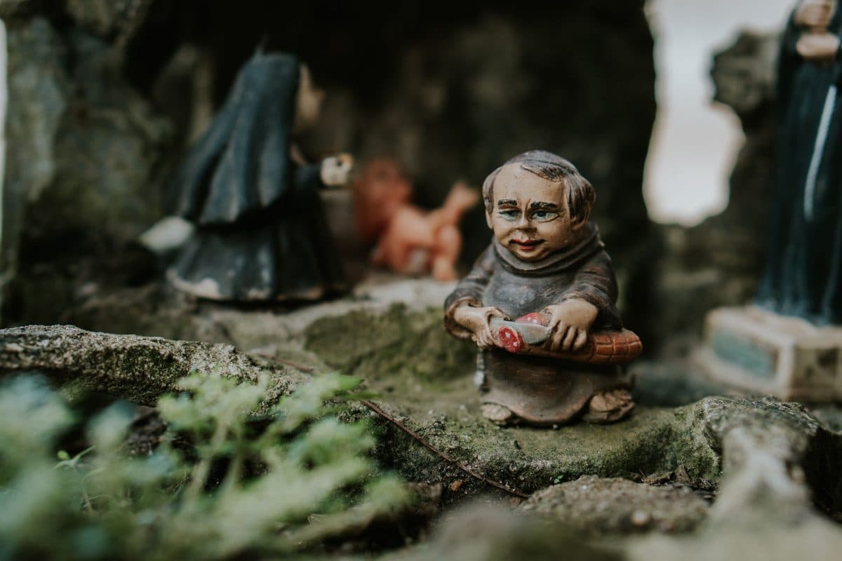 Small decorative figurines among green foliage