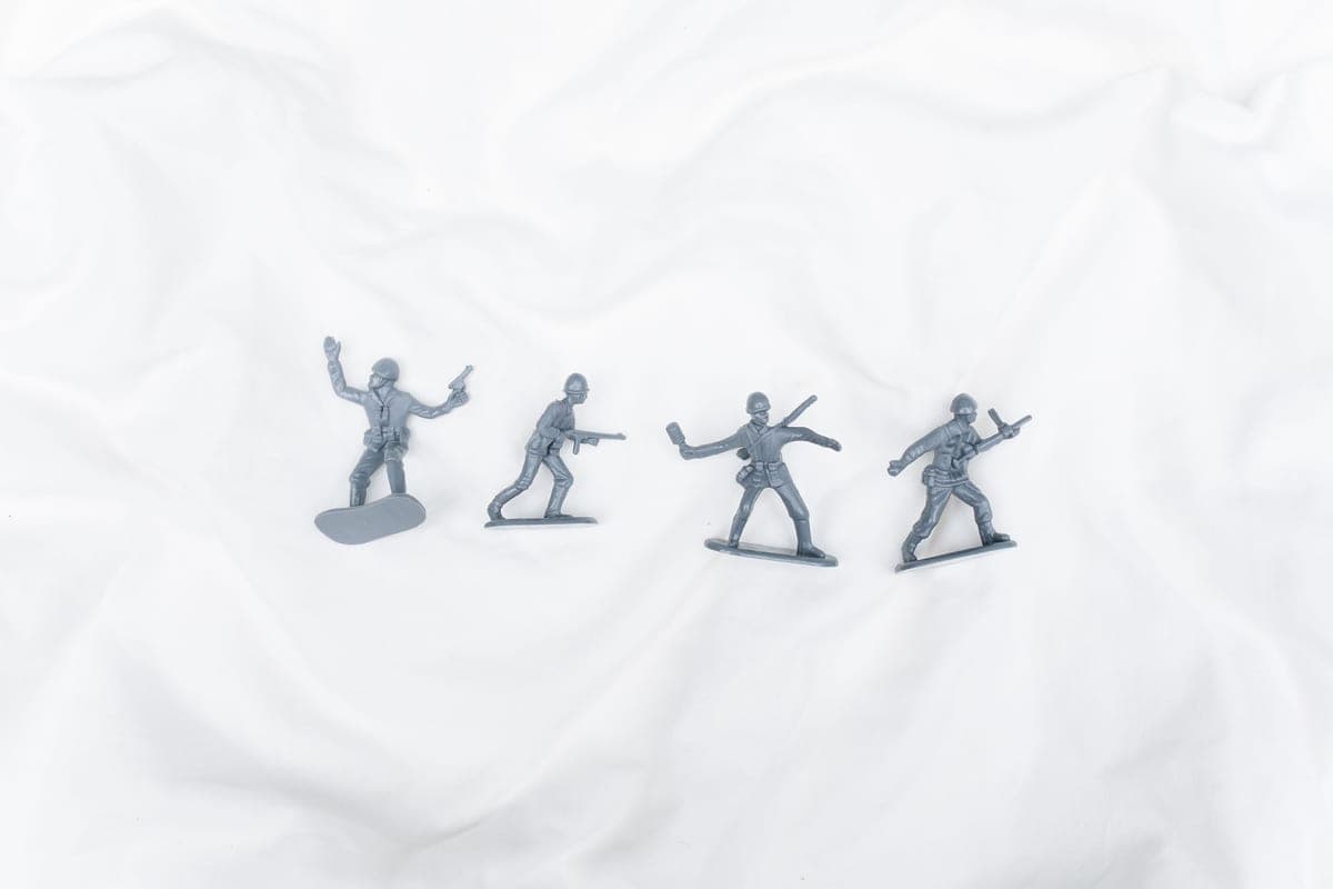 Small molded plastic figures arranged on a light sheet