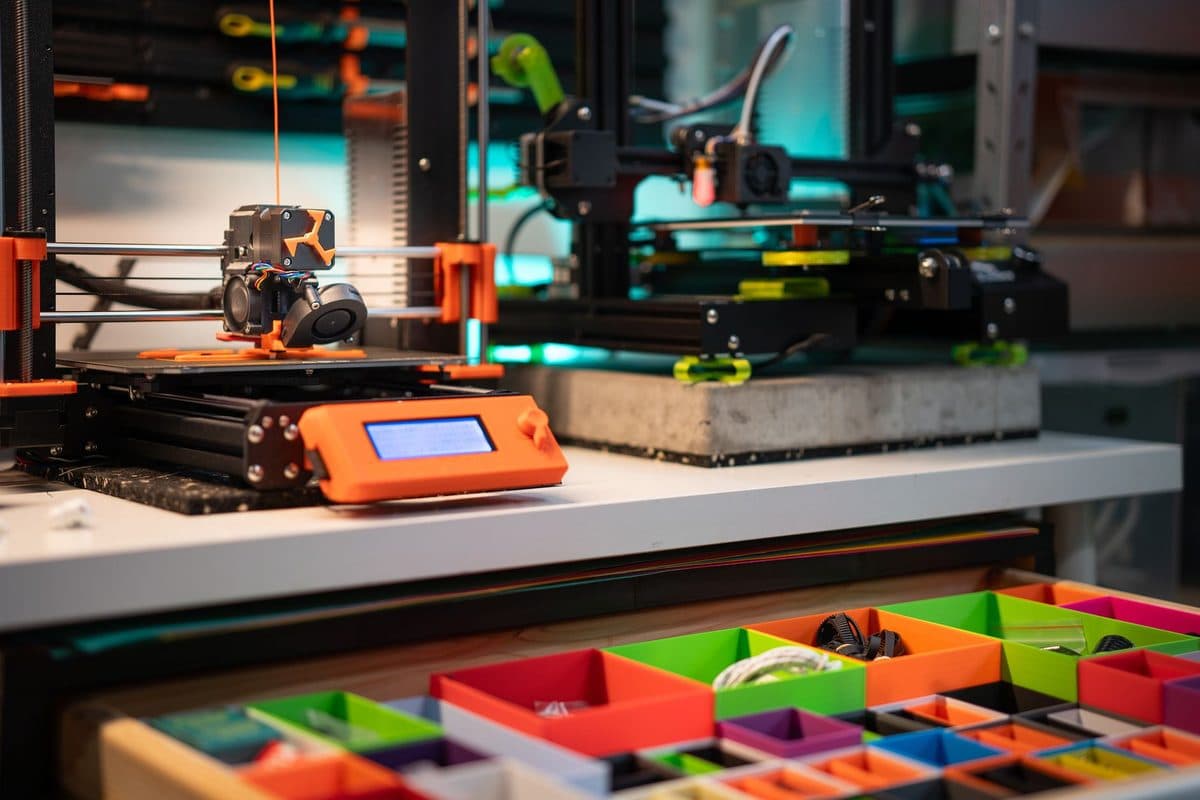 A 3D printing station with equipment and storage boxes arranged together