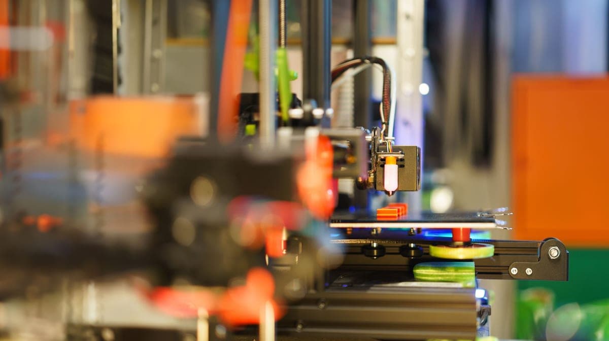 Several 3D printers running side by side in a home workshop